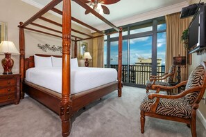 A four-poster bed with a view of the city, a zebra-patterned chair, and a television on the wall. - *4 Bedroom* Phoenix West! Balcony On The BEACH! Condo 1909 (Orange Beach)