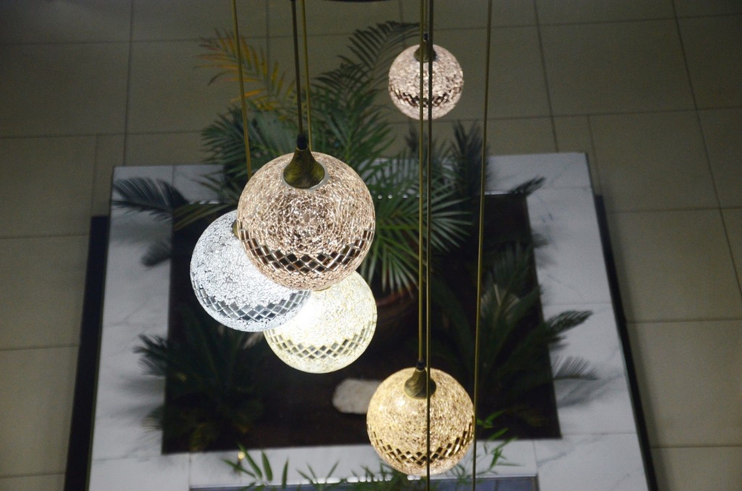 A chandelier with spherical, textured glass shades hanging from the ceiling.