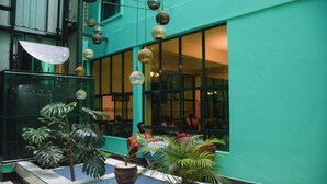 A building with large windows, indoor plants, and hanging lanterns. - Comfy Inn Eldoret (Eldoret)