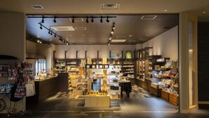 Botiga moderna amb una àrea d'exposició central, prestatges plens de diversos productes i una disposició neta i ordenada.