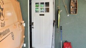 A garage entrance with a sign reading "STAR GARAGE," a fishing rod, and a red backpack. - Close to National Parks.The Star Garage, Sleep in a Vintage Truck Bed, Cool! (Kanab)