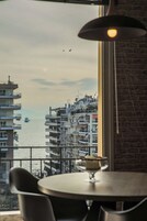 A view from a balcony overlooking a body of water with buildings in the background.