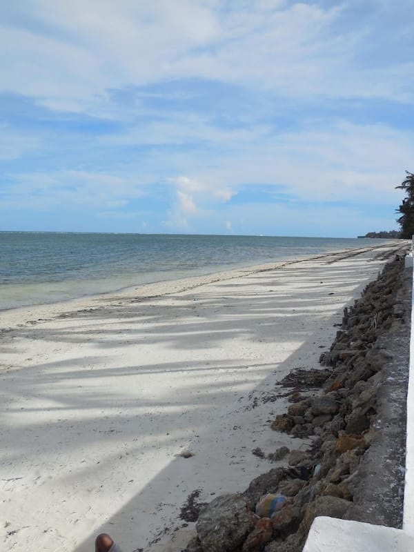On the beach, white sand, beach umbrellas, beach towels