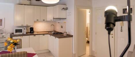 Deluxe Triple Room, Canal View | Private kitchen | Full-size fridge, microwave, stovetop, dishwasher