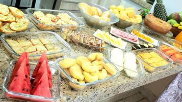Een buffet met diverse soorten eten en een ananas op het aanrecht.