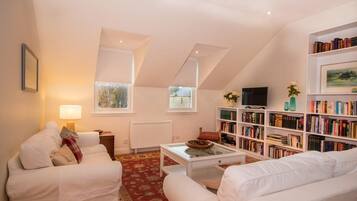 Flat-screen TV, DVD player, books