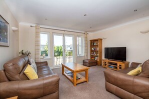 Flat-screen TV, books - 7 Crown Apartments (Inverness)