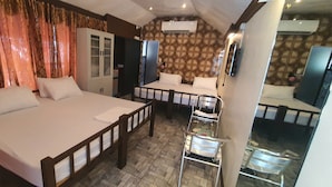 A hotel room with two beds, a wardrobe, and a mirror. - Cool Martin Resort Hotel (Bacoor City)