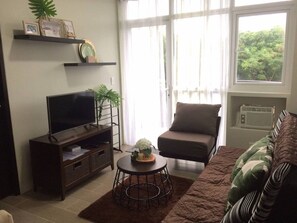 Apartamento, 1 quarto | Área de estar | TV de tela plana