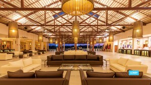 A spacious lobby with high ceilings, modern furniture, and a central seating area. - Vila Galé Resort Touros - All Inclusive (Touros)