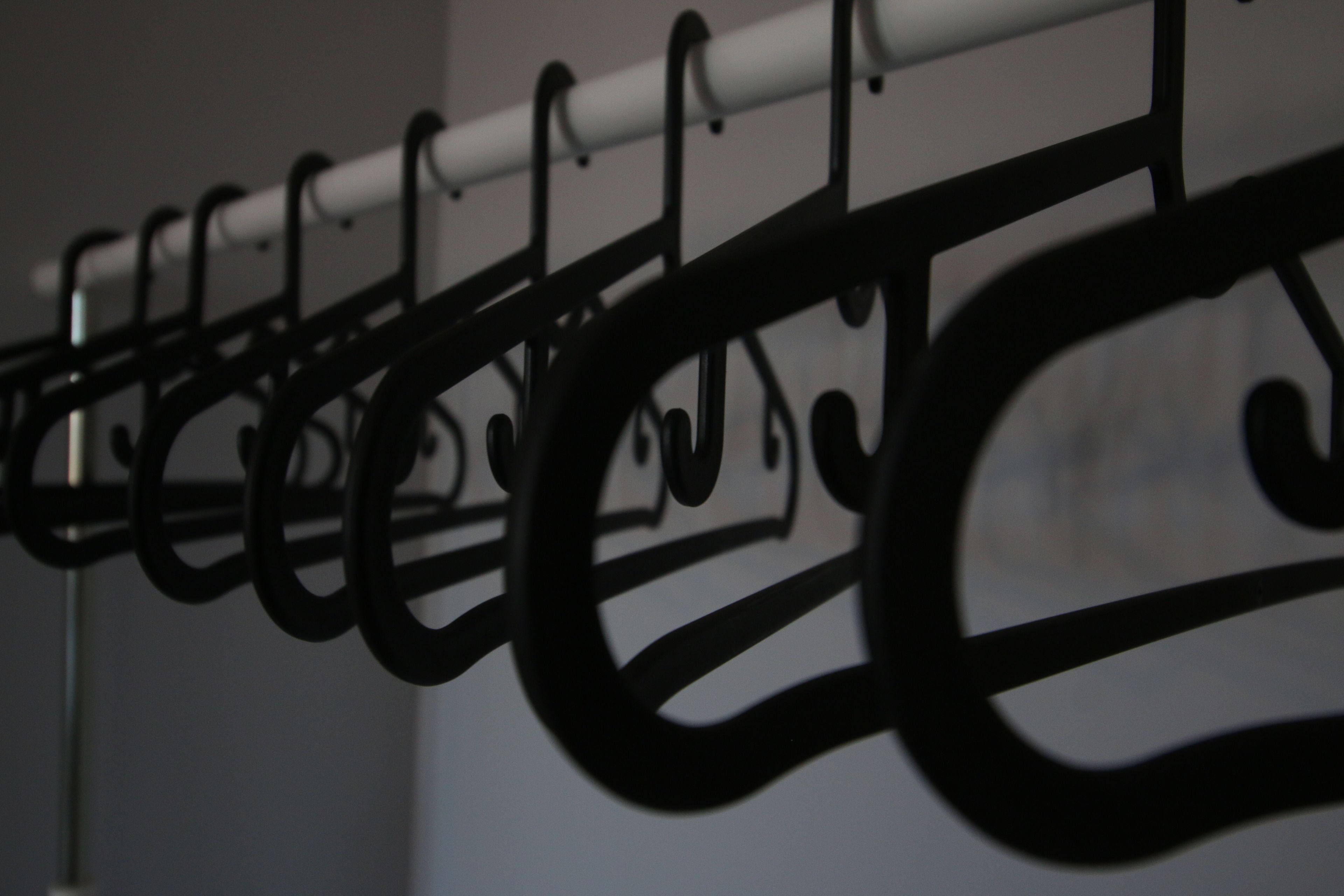 A rack of black hangers.