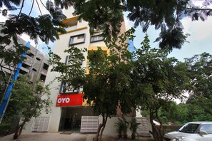 A building with a red sign reading "OYO" and a gated entrance. - OYO Flagship 674 HSR Layout (Bengaluru)