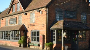 A traditional brick building with a sign reading "Bourne Valley Inn."
