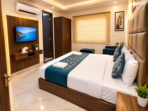 A modern hotel room with a large bed, a television, a wardrobe, and a window with a view. - Hotel Mayda Prime Near Delhi Airport (New Delhi)