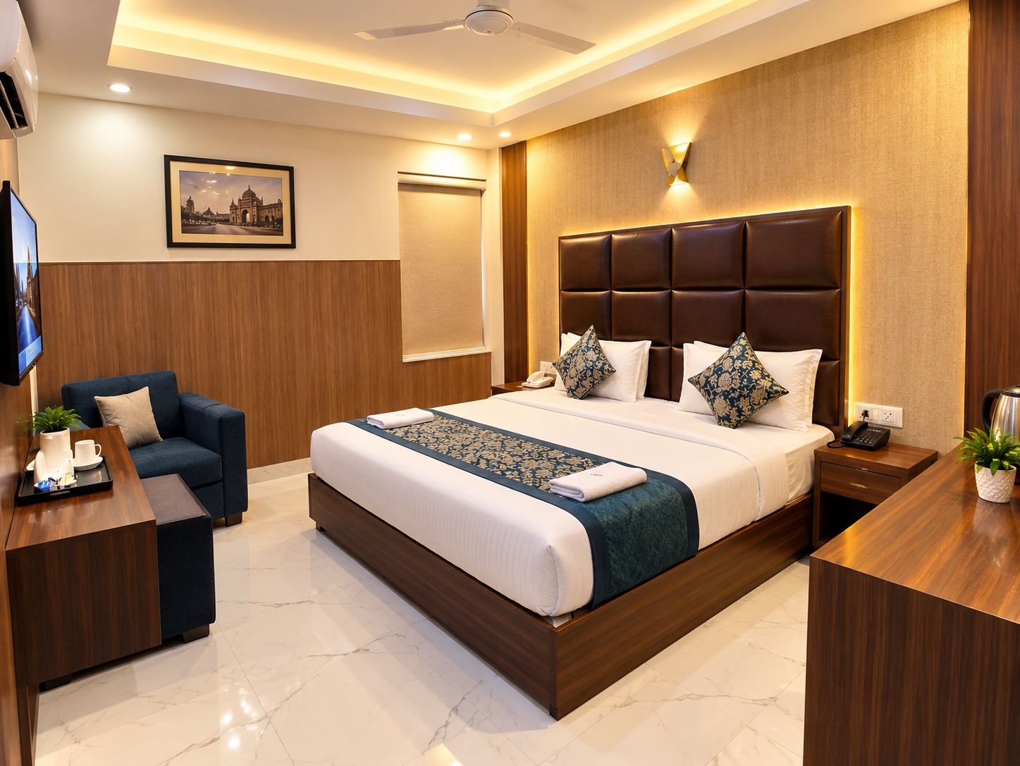 A hotel room with a large bed, a desk, a chair, a television, and a wall-mounted clock.