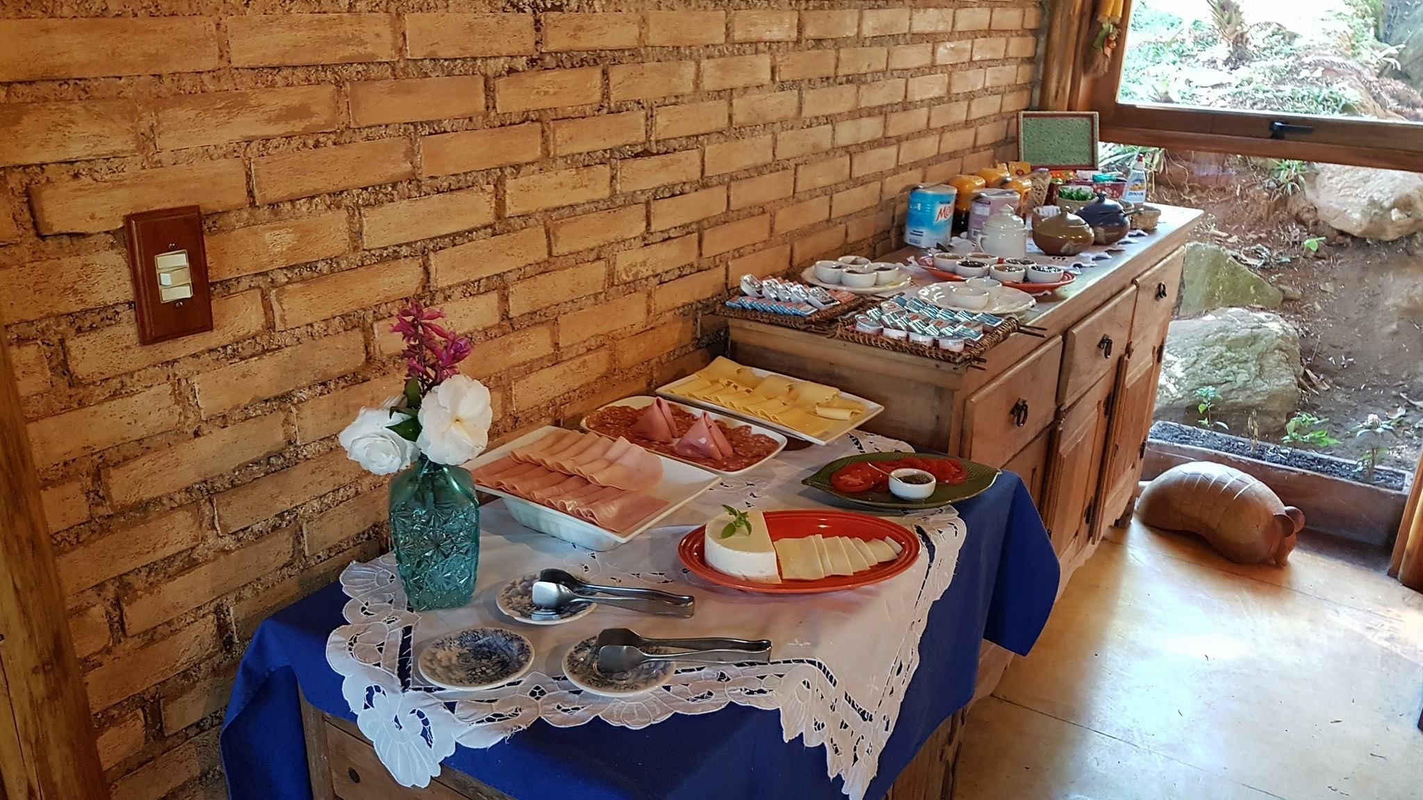 A buffet table with various food items and a vase of flowers.