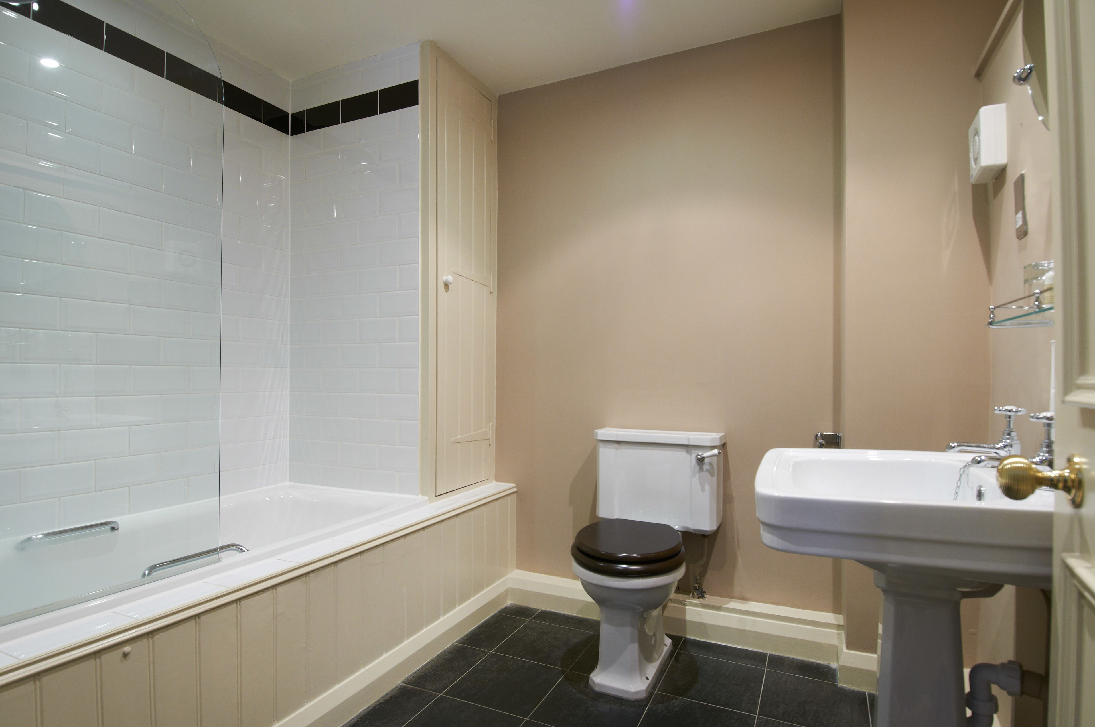 A bathroom with a bathtub, toilet, and sink.