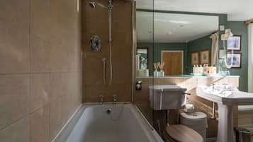 A modern bathroom with a bathtub, toilet, and sink.