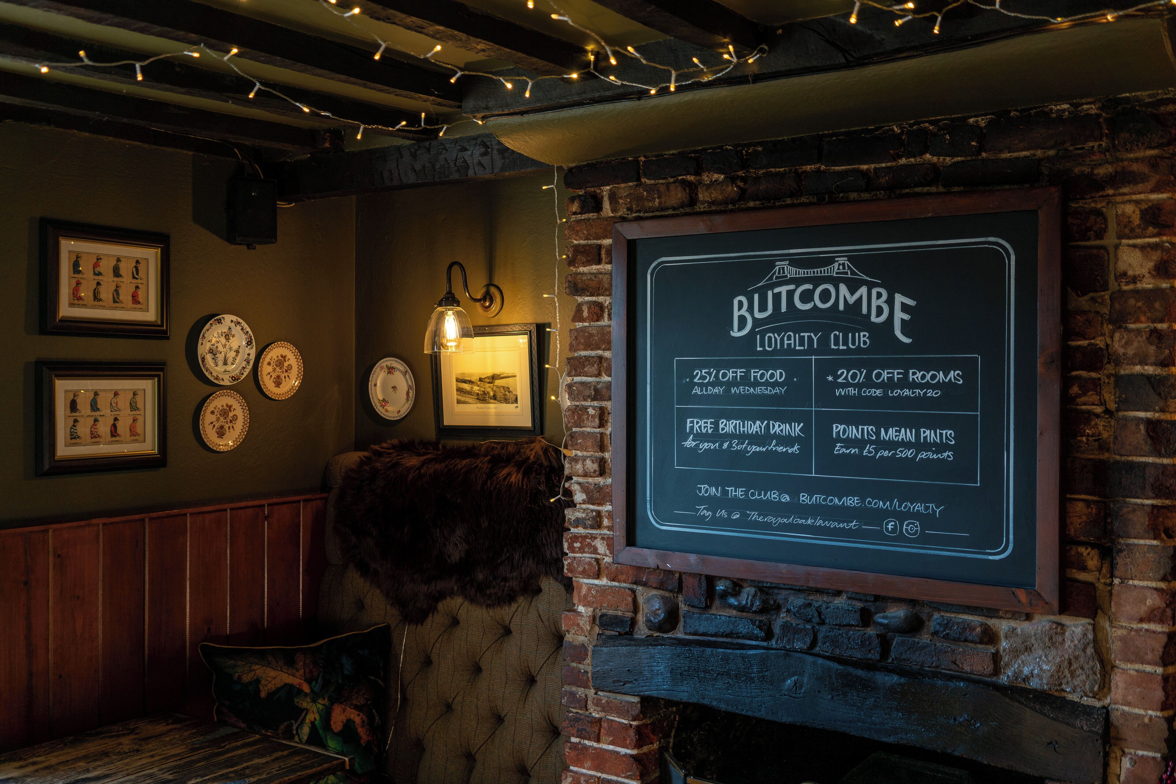 A Butcombe Loyalty Club signboard with details on offers and amenities.