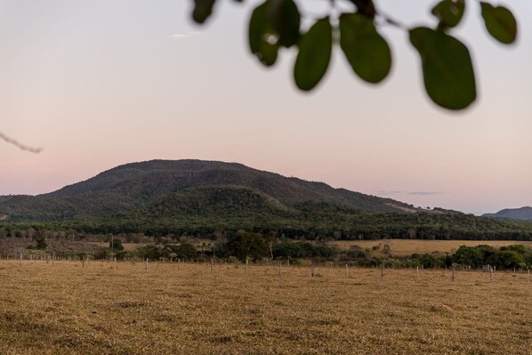 A landscape with a hill, a field, and a fence. - Shambala Piri (Pirenópolis)