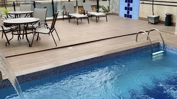 Outdoor pool, open 10:00 AM to 10:00 PM, pool loungers