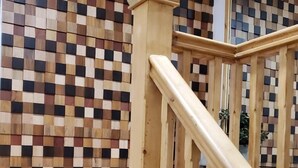 A wooden staircase with a checkered wall pattern in the background. - The Bell Gate House (Leicester)
