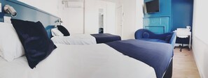 A hotel room with two beds, a desk, a chair, and a TV. - The Bell Gate House (Leicester)