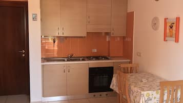Apartment, 1 Bedroom | Private kitchenette | Full-size fridge, oven, stovetop, cookware/dishes/utensils