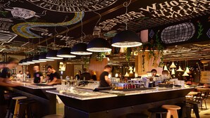 A bar area with a central island, stools, and hanging lights. - Mama Shelter Belgrade (Belgrade)