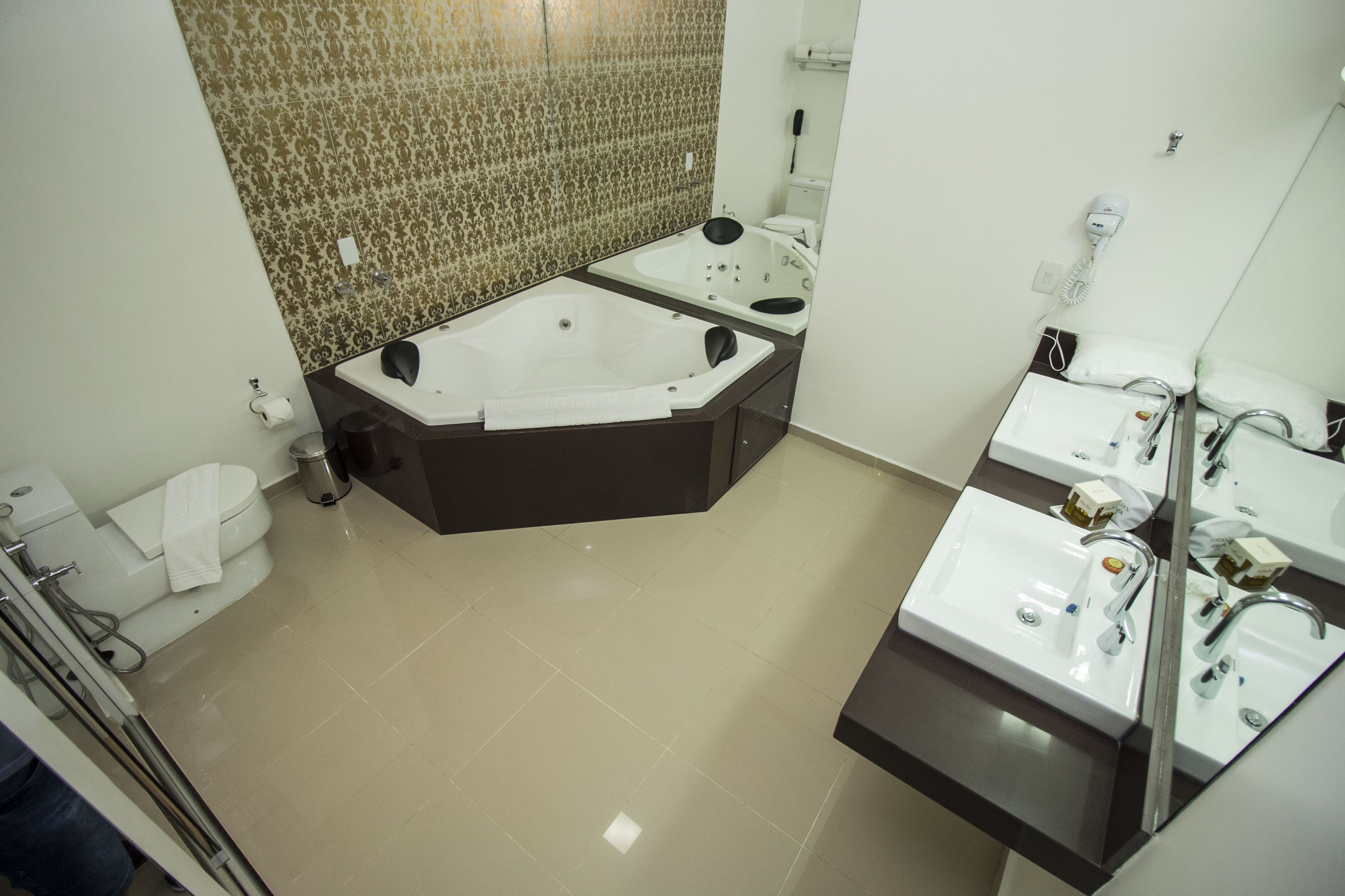 A modern bathroom with a large bathtub, a separate shower area, and a vanity with a sink.
