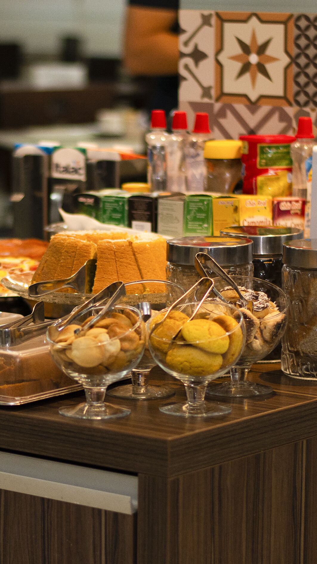 A buffet with various food items and condiments.