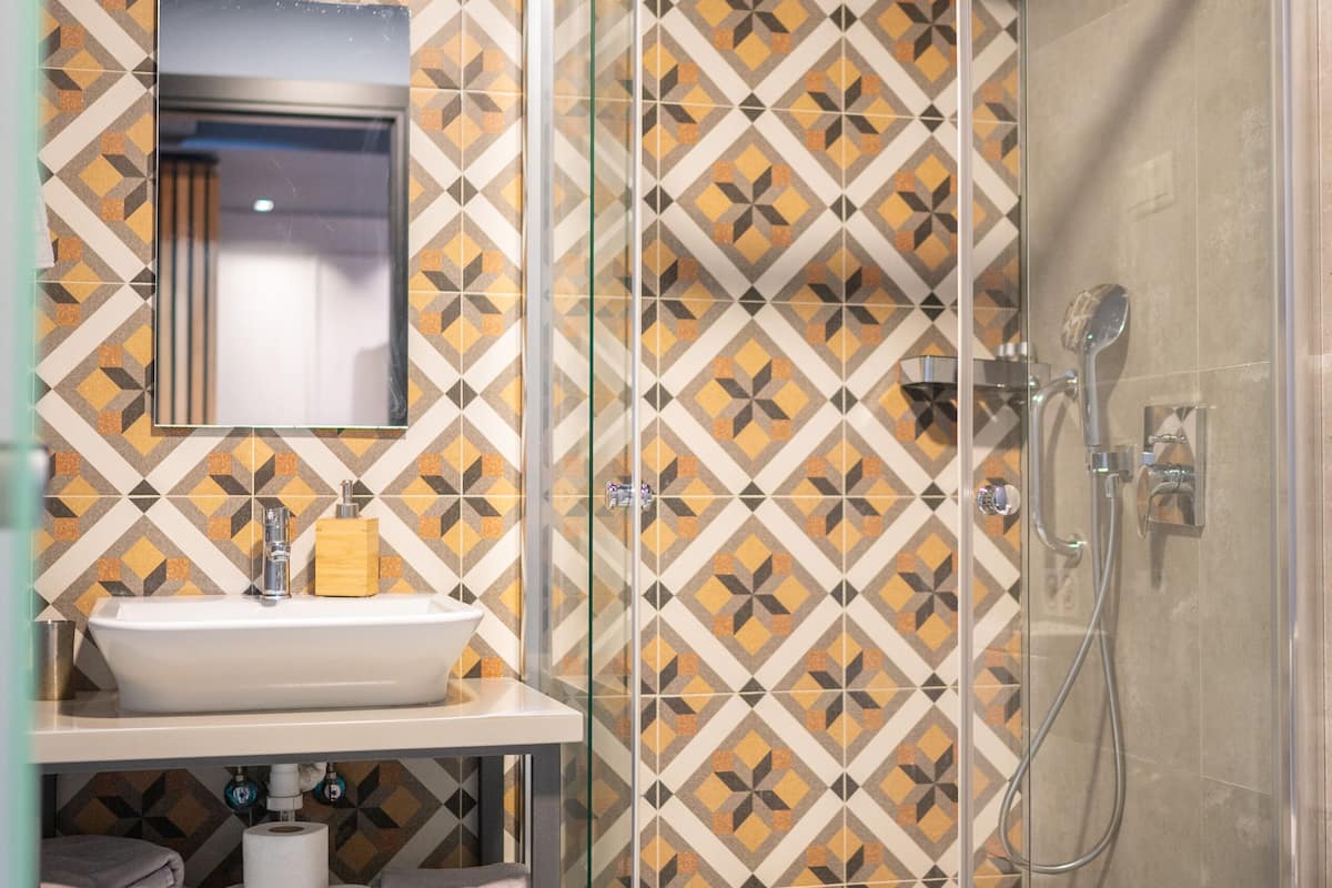 shower, rainfall showerhead, hair dryer, towels