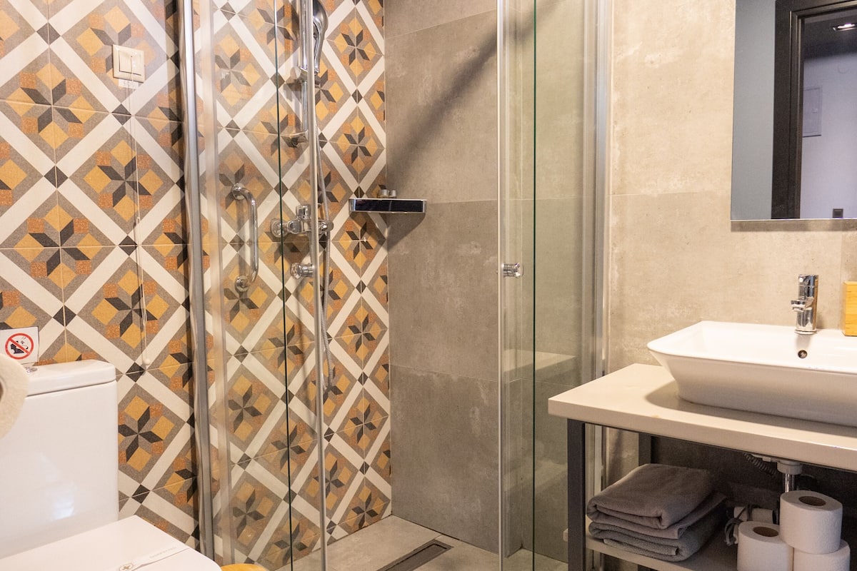 shower, rainfall showerhead, hair dryer, towels