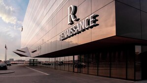 A modern building with a prominent 'Renaissance' sign on the facade. - Renaissance Warsaw Airport Hotel, an Marriott International (Warsaw)