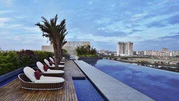 Outdoor pool, open 6:00 AM to 10:00 PM, pool loungers