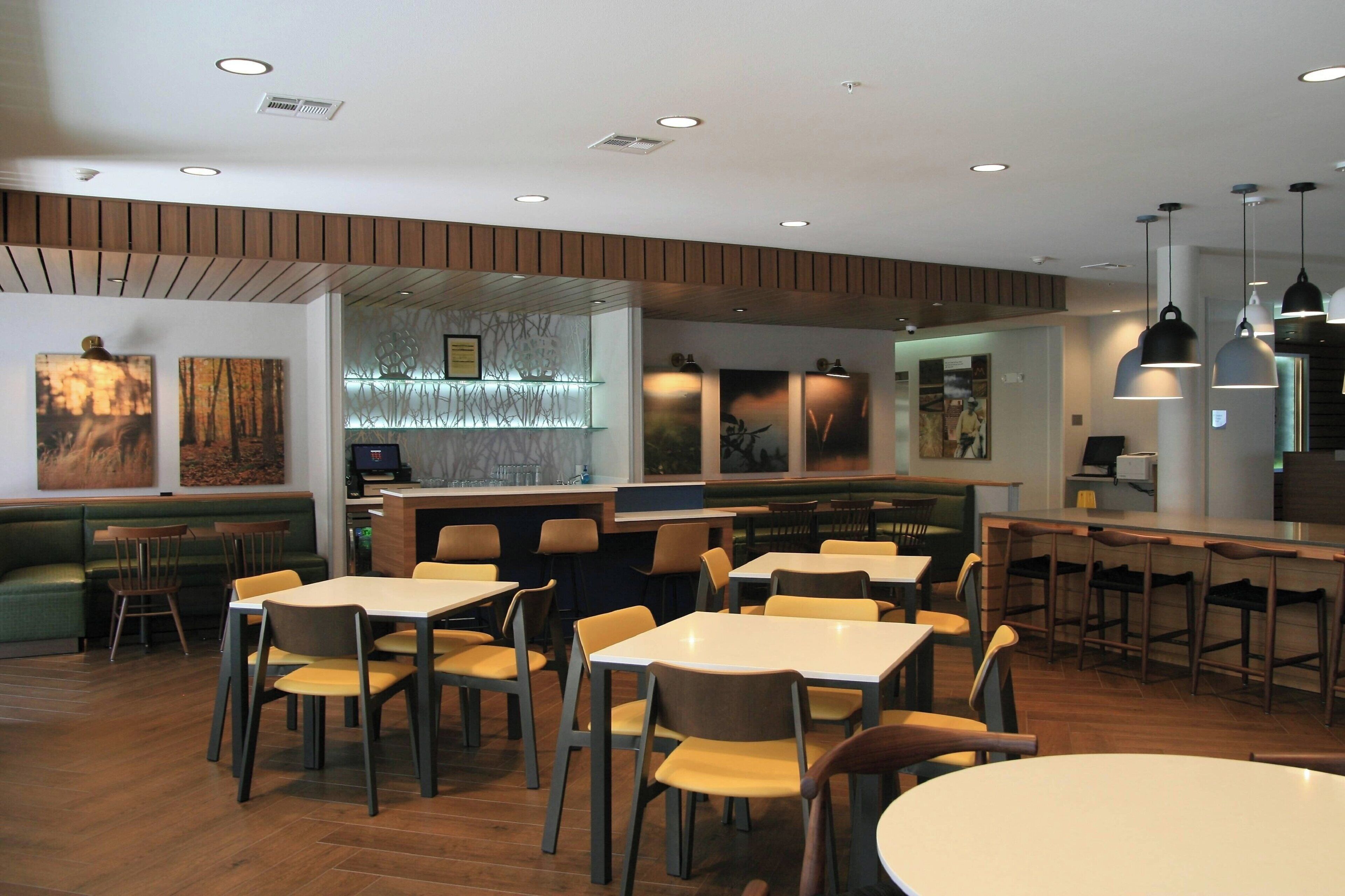 A restaurant with booths, tables, and a bar area.