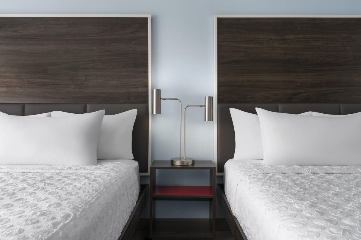 Premium bedding, down comforters, blackout drapes, iron/ironing board