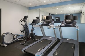 A fitness room with treadmills, an elliptical, and a stationary bike. - Tru by Hilton Chicopee Springfield (Chicopee)