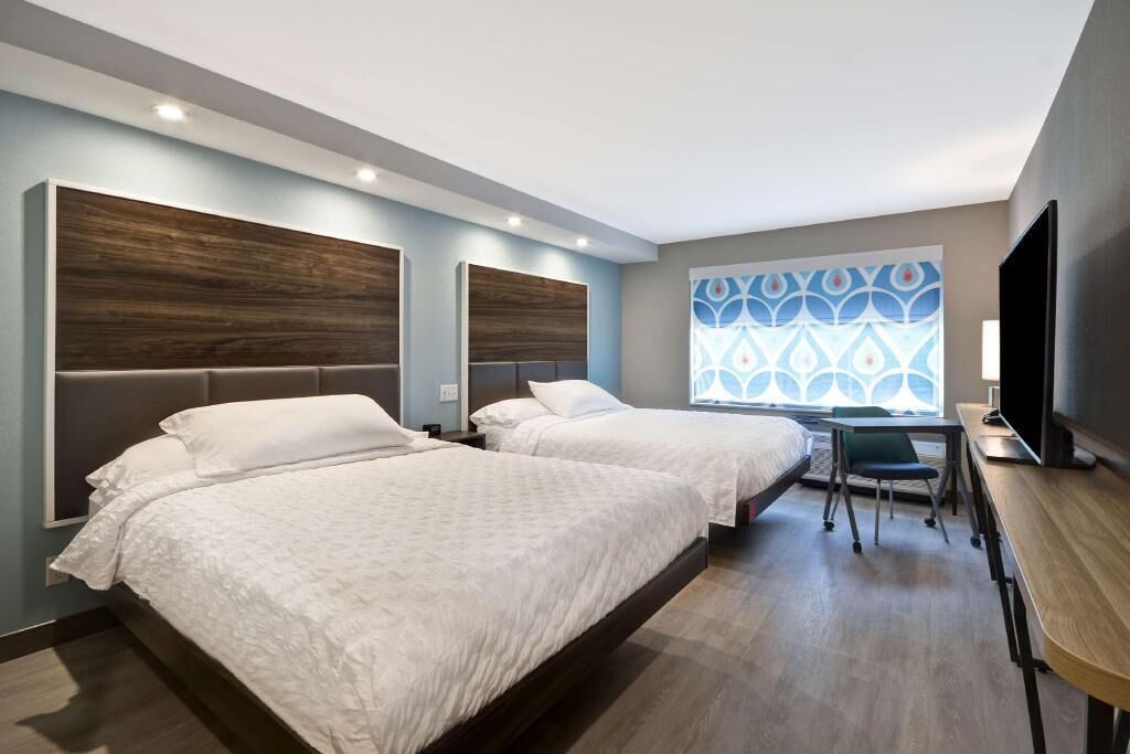 Premium bedding, down comforters, blackout drapes, iron/ironing board