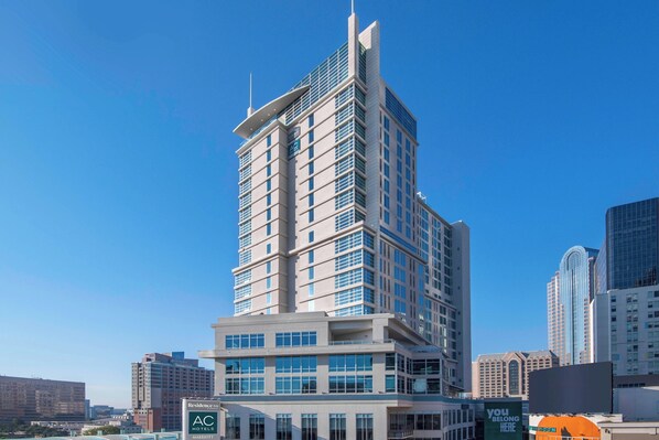 A high-rise hotel with multiple floors, large windows, and a prominent AC logo. - AC Hotels by Marriott Charlotte City Center (Charlotte)