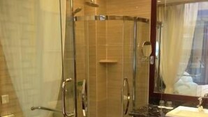 A modern bathroom with a glass-enclosed shower, a toilet, and a vanity with a sink. - Hanyun Huidu Hotel (Huaibei)