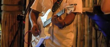 A person playing an electric guitar.