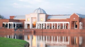 A building with a central dome and a reflective water body in front. - Southern Luxury: Eastchase District 4bd / 3bth (Montgomery)
