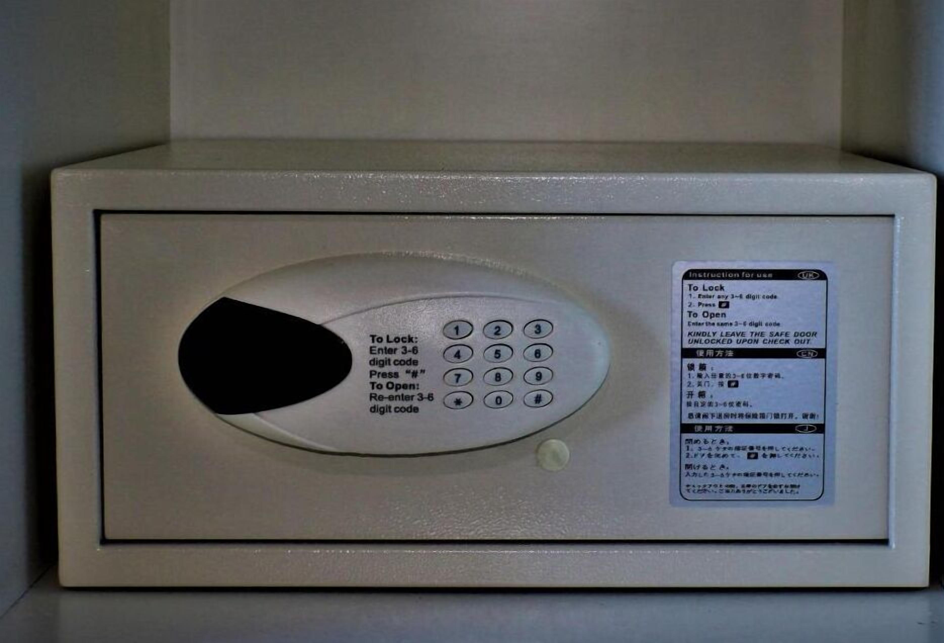 A digital safe with a keypad and instructions for use.