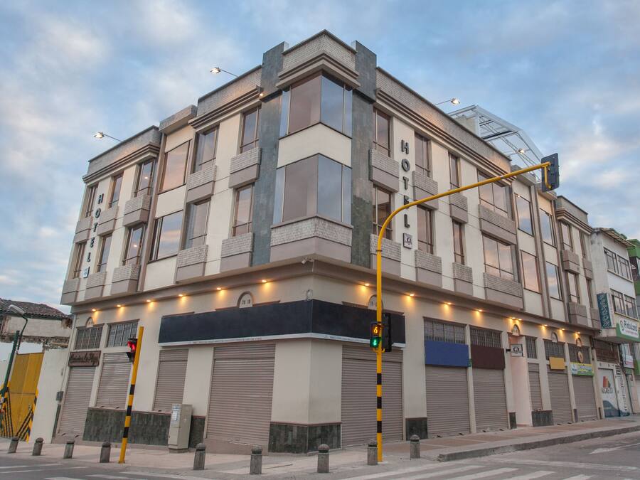 A hotel with a modern facade, large windows, and a prominent 'HOTEL' sign.
