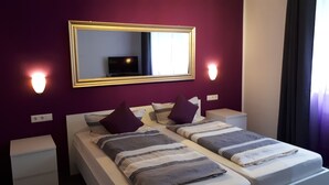 A twin room with two beds, a large mirror, and wall-mounted lights. - Pension Elisabeth (Cochem)