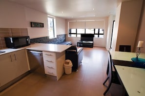 Enjoy cooking in this well-lit kitchen with a central island featuring a sink, microwave, and dishwasher.