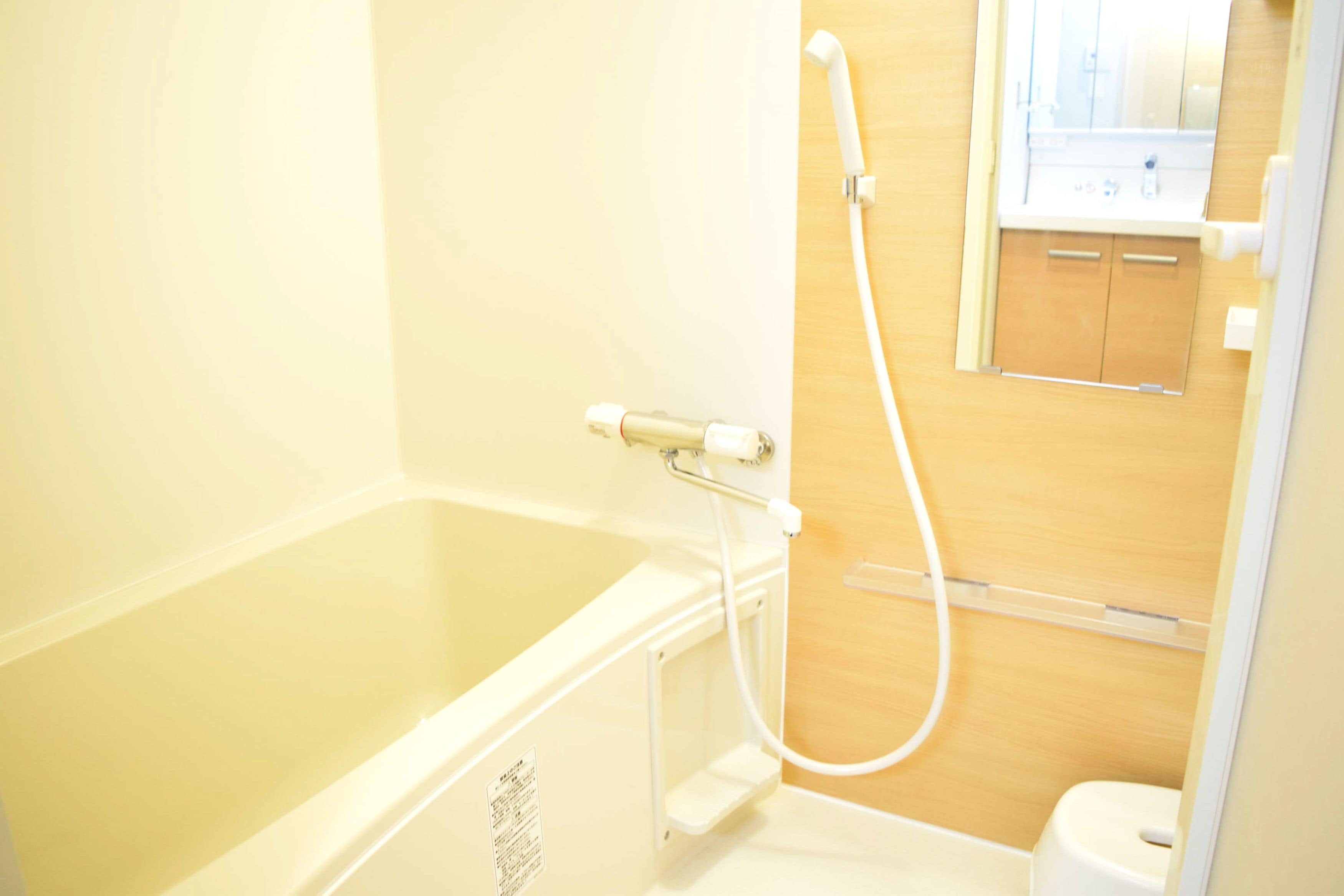 A bathroom with a bathtub, a shower, and a toilet.