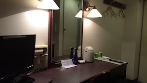 A hotel room with a desk, a flat-screen TV, a coffee maker, and a mirror. - Hotel Town Nishikigawa (Kochi)
