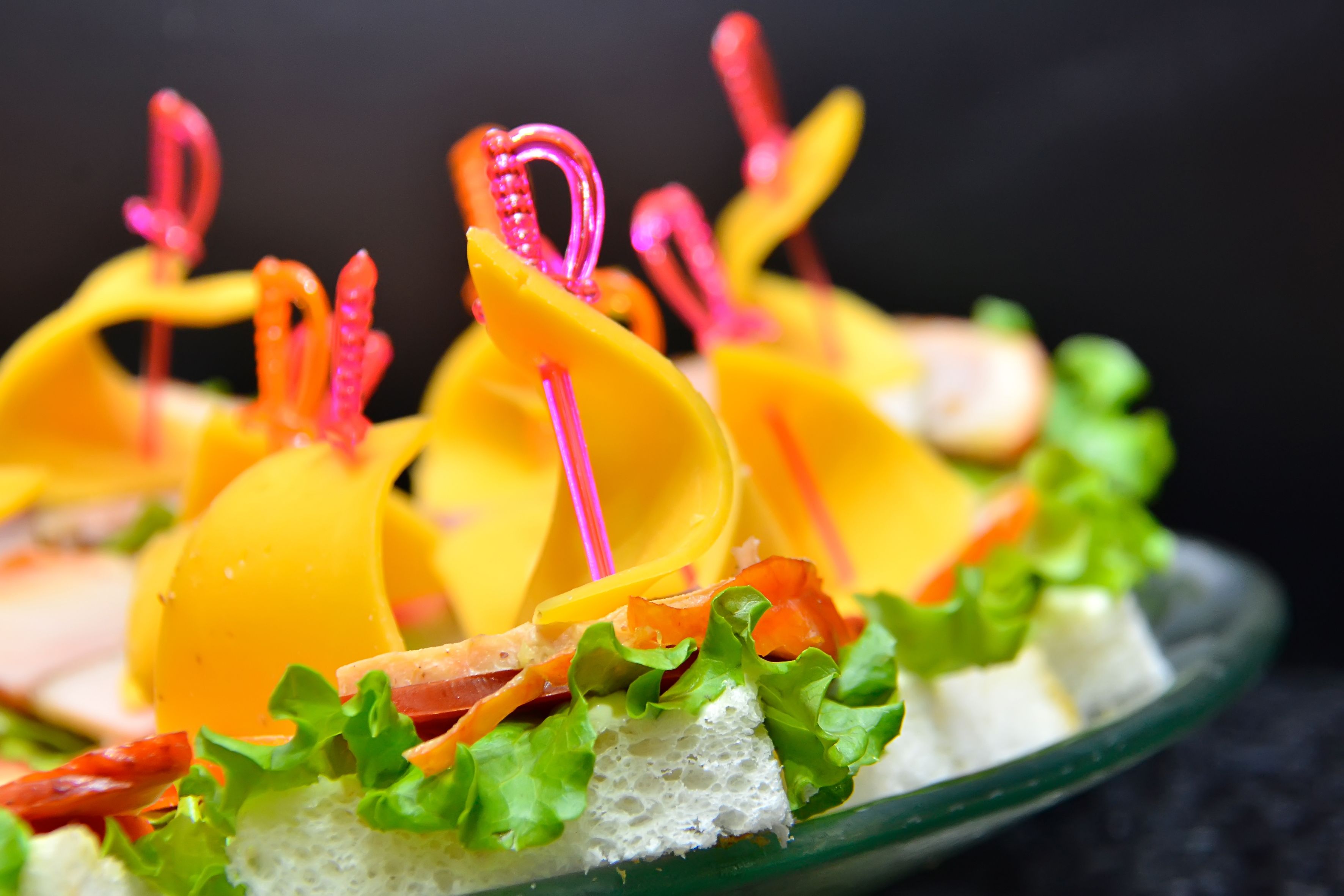 A close-up of a colorful food arrangement with various fruits, vegetables, and a glass dish.